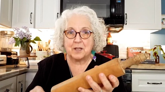 I tried to use my mom's old rolling pin recently and it felt sticky.  My dad "oiled" it with vegetable oil because the wood was dried out.  Is there a way to repair/draw oil out so it isn't sticky?